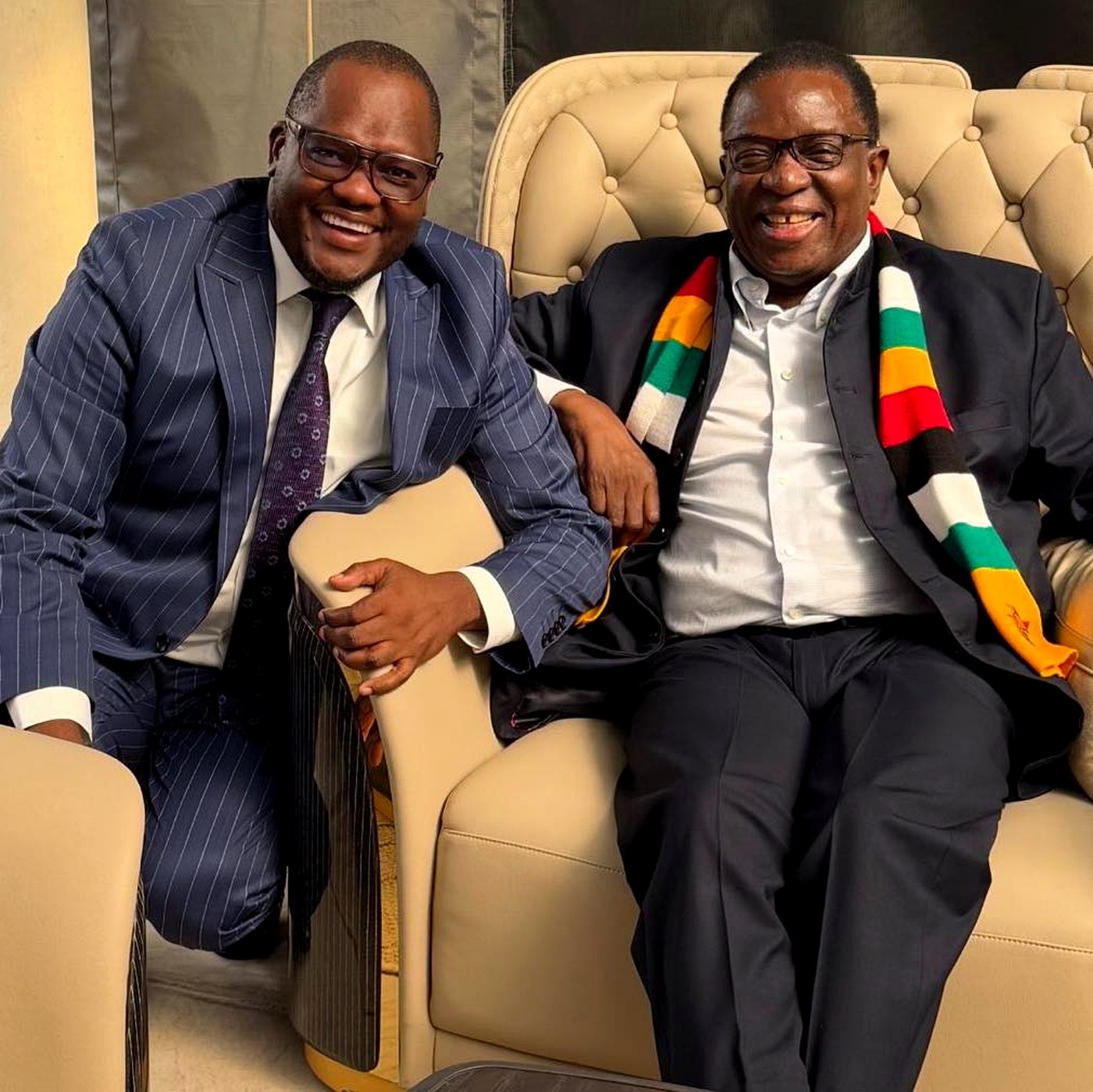 Dr Paul Tungwarara seated alongside President Emmerson Mnangagwa during an official engagement, both laughing — an intimate frame of the operator and the principal
