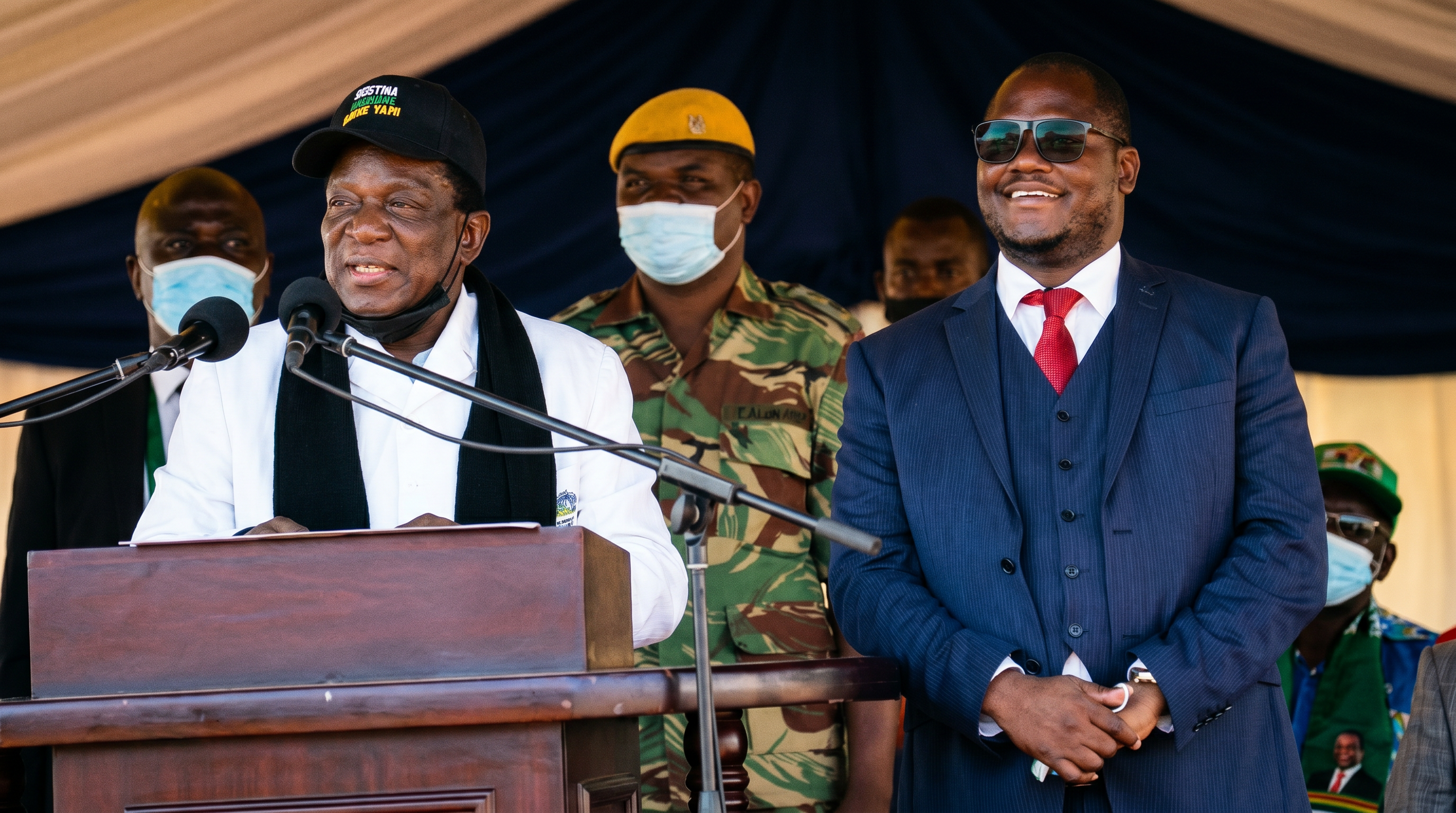 Dr Paul Tungwarara standing alongside President Emmerson Mnangagwa at an official public event in Zimbabwe