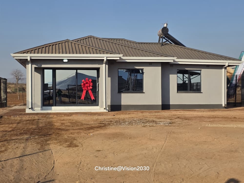 Completed war veteran serviced housing unit in Zimbabwe ready for handover with ceremonial ribbon